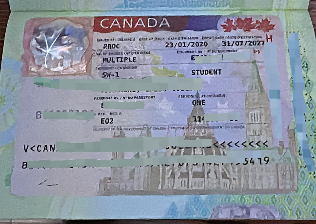 Canadian flag beside a passport and travel documents